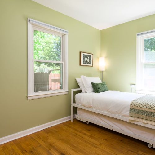 This first-floor bedroom features a trundle bed with two twin mattresses - perfect for kids, friends, or a cozy solo stay.