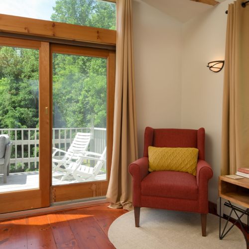 Natural light, wooded views, and direct balcony access create a peaceful corner to unwind.