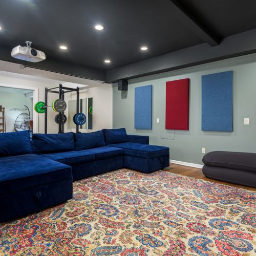 A multifunctional lower level designed for both downtime and productivity - sink into the cozy sectional, or head to the gym and office just beyond.