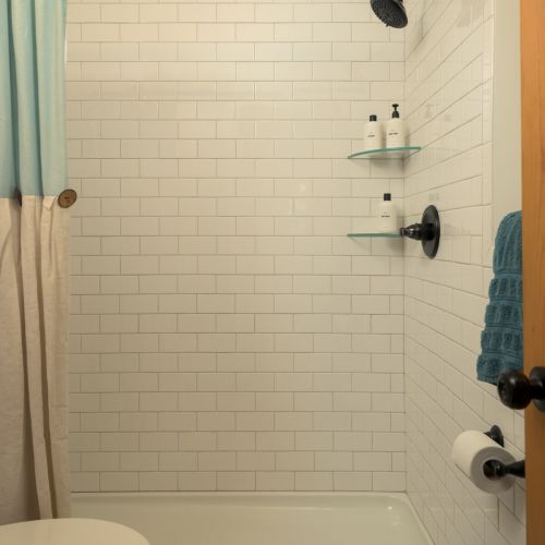 The downstairs bathroom features a spacious walk-in shower stocked with essentials for your stay.