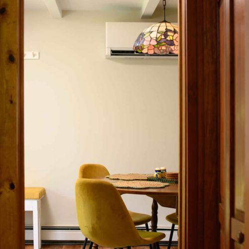 Bright and welcoming, the dining area connects the kitchen, deck, and backyard.
