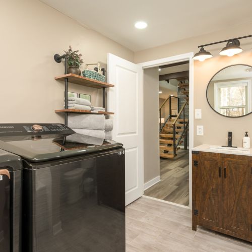 Unwind with a warm soak or keep things practical with in-home laundry - this full bath is both stylish and functional.