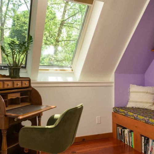 A cozy reading nook and dedicated workspace make the loft an inviting place to relax, reflect, or catch up on a good book.