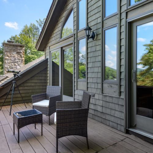 Tucked between two bedrooms, this peaceful balcony offers front-row lake views and cozy seating for two.