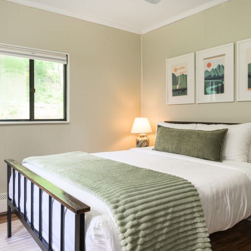 Simple and serene - this ground-floor retreat features a queen bed, smart TV, and mirror, with both blackout and light-filtering shades to suit your rhythm.
