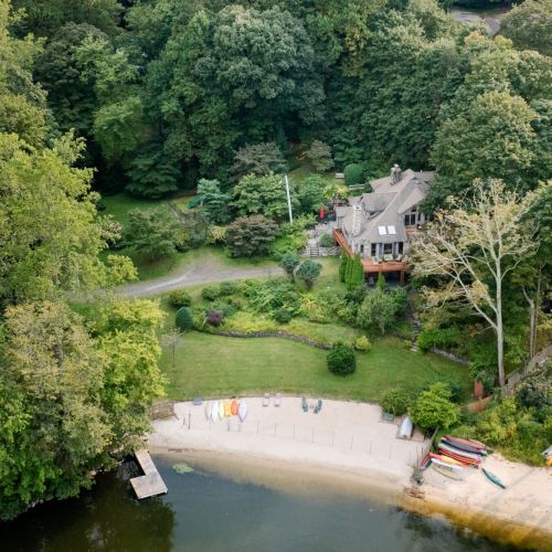 Soak in the serenity from above—private dock, shoreline kayaks, and the cozy charm of your own waterfront hideaway.
