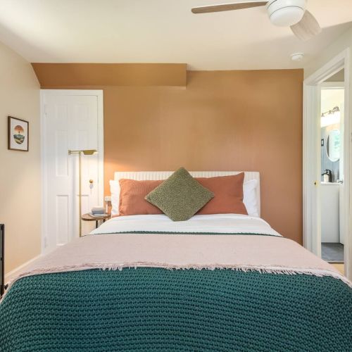 Settle into soft linens and blackout shades in this inviting queen bedroom - designed for quiet mornings and restful nights.