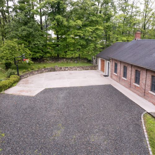 Plenty of space to park, play, and shoot some hoops - this wide driveway is ready for both fun and function.