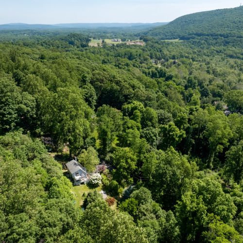 Nestled among acres of mature trees, the property feels wonderfully secluded while remaining close to local attractions.