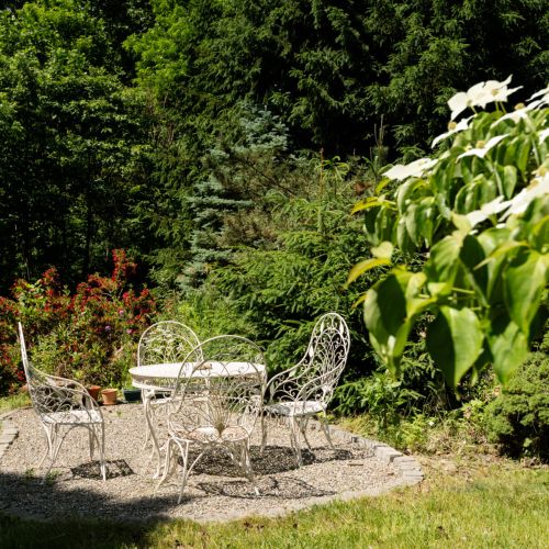 Surrounded by greenery, the garden patio offers a peaceful place to relax and enjoy the fresh air.