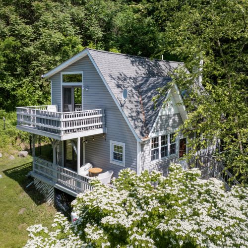 Tucked among the trees, this peaceful retreat offers multiple outdoor spaces to unwind and reconnect with nature.