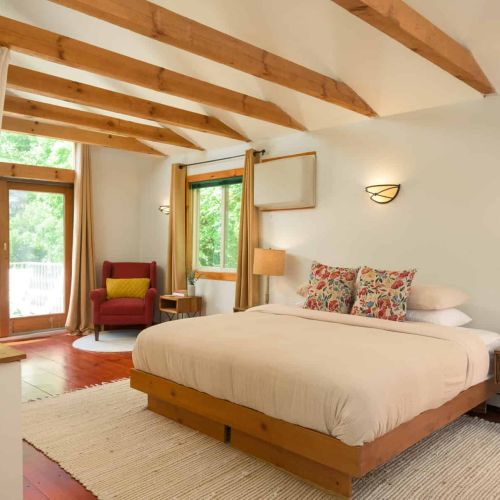 Retreat to the airy loft suite, featuring a king bed, private balcony access, and a peaceful setting perfect for slow mornings and restful days. Please note this loft is open to the first floor. We provide curtains for privacy, but there is no door.