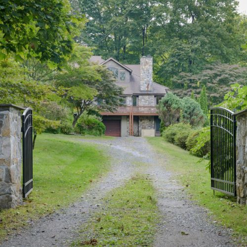 Tucked behind these welcoming gates, Aqua Lodge offers a private lakeside escape where peace, comfort, and nature meet.