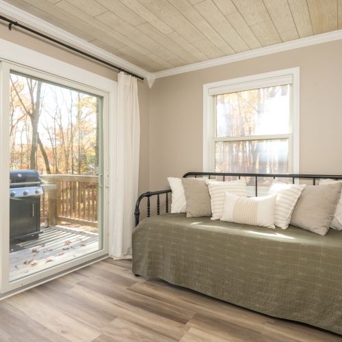 Work with a view - our dedicated office space features lakefront windows and a comfy daybed for midday reading or journaling breaks.