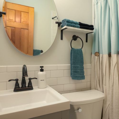 The main-floor full bathroom is thoughtfully stocked and conveniently located near the downstairs bedroom.