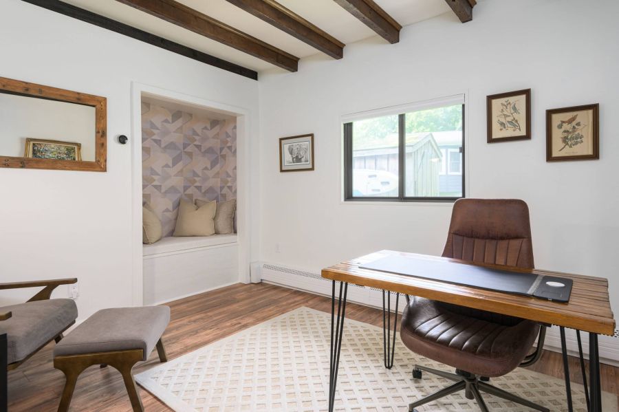 Vacation rental management services for a stylish neutral office with desk and reading nook