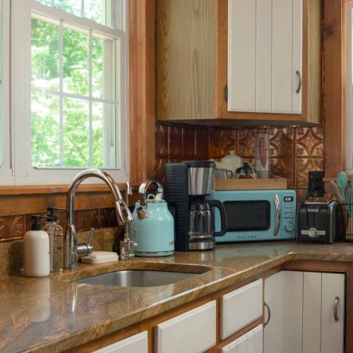 Brew a pot in the Ninja coffee maker and ease into the day with sunlight streaming through the kitchen windows.