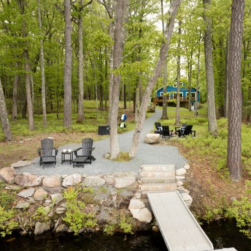 From deck to dock, this sweeping lakefront yard brings it all together - kayaks, firepit, and private lake access included.
