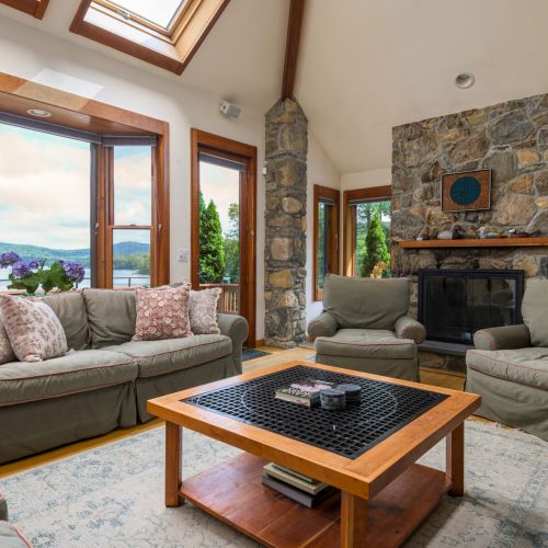Gather here after a lake day — plush seating, peaceful views, and the charm of stone fireplaces (for looks only, no flames!).