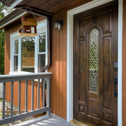 Step up to a warm welcome - our charming entryway, complete with a hanging birdhouse, sets the tone for a peaceful stay.