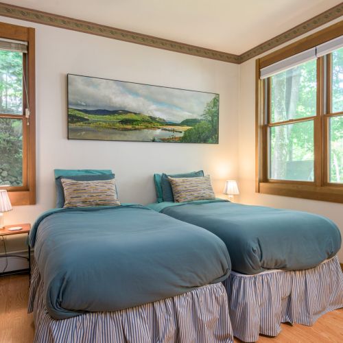 Wake up to lake views in this cozy twin room — perfect for kids, friends, or anyone who loves a room with a view.