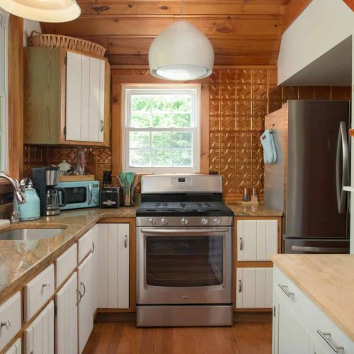 This thoughtfully equipped kitchen features a Ninja drip coffee maker, full-size appliances, and plenty of space for preparing meals together.