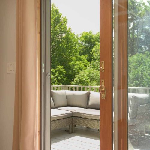 Step outside to a private balcony featuring comfortable sectional seating and additional lounge chairs.