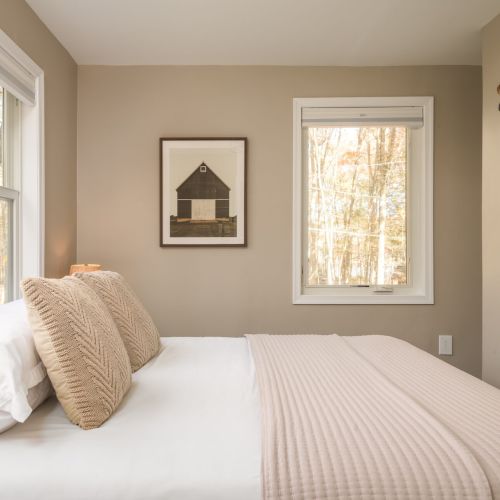 Cozy and calm, this full-size bedroom on the lower level is a restful retreat with soft lighting and blackout shades.