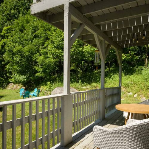 Relax on the shaded porch and take in views of the surrounding greenery and outdoor gathering spaces.