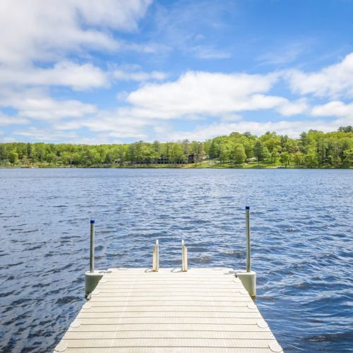Peace, paddles, and panoramic views - standing on the dock is where lake days begin and stress melts away.
