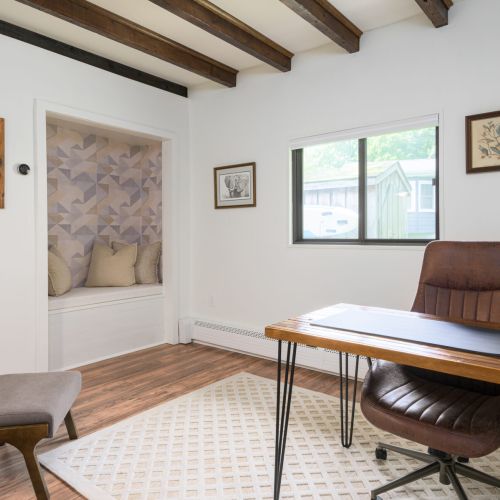 Whether you're logging on or logging off, this charming office offers a comfy desk setup and a closet-turned-reading nook with a record player to set the mood.