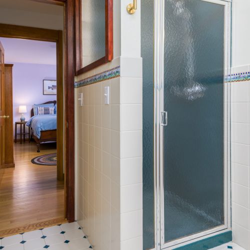 Fresh and functional — this full bathroom features a sleek shower stall and all the essentials to start or end your day with ease.