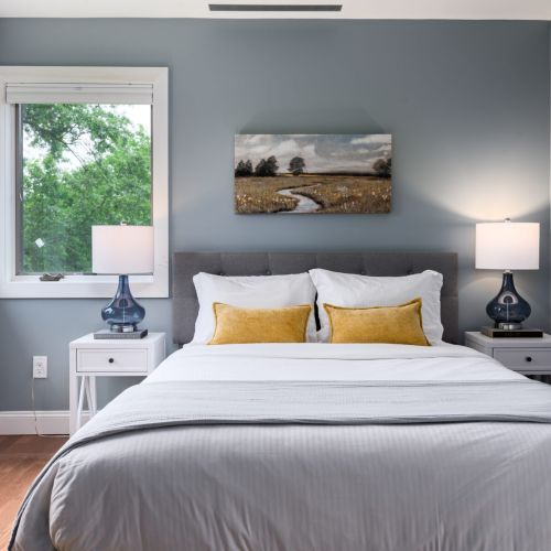 Natural light pours into this peaceful queen room, complete with a full-length mirror and soft linens made for rest.