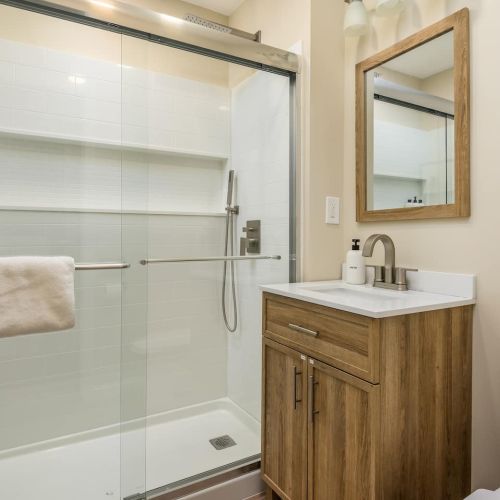 The first-floor bathroom features a spacious walk-in shower and simple, clean design.