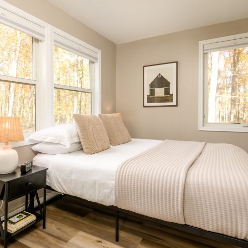 Tucked away downstairs next to the kitchen, this charming bedroom offers quiet comfort - perfect for early risers or guests seeking a little extra privacy.