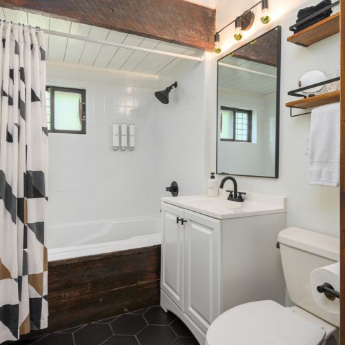 A touch of rustic charm - this full bath features a classic tub/shower combo, perfect for unwinding after a day outdoors.