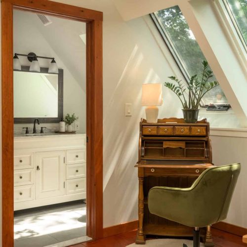 Natural light pours through the skylights, creating a bright and inviting loft retreat with a dedicated workspace and private bath.