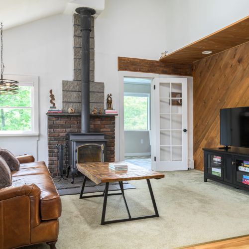 Cozy up on the leather couch for movie nights and slow mornings - please note, the fireplace is for ambiance, not in use. Living Room contains a 50" Amazon Fire TV where you can log into any of your apps. The TV stand holds a ton of board games for hours of fun.