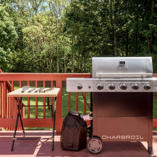 The gas grill is ready for your summer favorites - complete with grilling tools and easy access to the dining area for effortless outdoor entertaining.