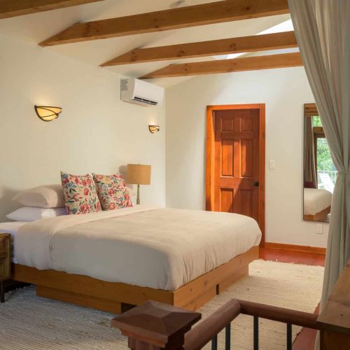 The spacious loft suite features a king bed, full length mirror, soaring ceilings, and warm wood accents throughout. Please note this loft is open to the first floor. We provide curtains for privacy, but there is no door.