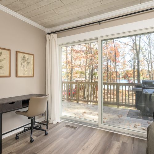 Need a quiet moment? This serene workspace with lake views and a cozy daybed is perfect for remote work, reflection, or unplugging in peace.